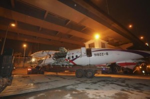 Wreckage of TransAsia Airways plane Flight GE235 is transported on the back of a truck after it crash landed into a river, in New Taipei City