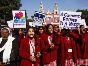 Demonstrators shout slogans as they hold placards during a protest outside a church in New Delhi