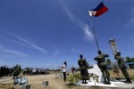 Filipino residents and soldiers conduct a flag raising ceremony during the visit of Armed Forces of the Philippines military chief General Gregorio Catapang in Pagasa Island (Thitu Island) at the Spratly group of islands in the South China Sea, west of Palawan, Philippines, May 11, 2015.  REUTERS/Ritchie A. Tongo/Pool