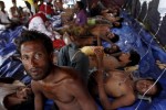 Rohingya and Bangladeshi migrants who arrived in Indonesia by boat receive medical assistance at an aid station in Kuala Langsa in Indonesia's Aceh Province May 15, 2015. REUTERS/Roni Bintang