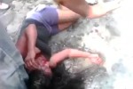 Pic shows: Moment the girl is bleeding from the face as the mob surround her.

Horrific video of a vigilante mob burning a girl to death after beating her up has gone viral.

The shocking 4-minute-38-second clip shows the 16-year-old girl bleeding from the face as the baying mob surround her in the village of Rio Bravo, 77 miles west of the Guatemala capital, Guatemala city.

According to reports, the girl who has not been named but is said to have been a clothes seller, was set upon after allegedly murdering a taxi driver.

Locals say the girl and two men shot driver Carlos Enrique González Noriega, 68, dead before robbing him and running off.

The two men fled down a series of alleys, but the girl took a wrong turn and was surrounded by the fuming 250-strong mob.

After viciously beating her, the video shows her stumbling around bleeding from the face.

At one point she is punched to the ground and set upon again as the mob demand justice.

She is then set on fire and filmed writing and screaming in pain as the lynch mob watch on.

At one point she tries to run away but then collapses on the ground in flames.

As she lies burning to death, a man runs over with a can of petrol and puts it over her sending her up in flames again.

The girl screams out in pain and then passes out.

The mob, which include children, continue to stand and watch as her lifeless body is consumed by flames and left as a smouldering corpse.

A police spokesman said that officers had tried to intervene but were blocked by the vigilante mob.

The video which was uploaded to YouTube has since been removed after being viewed hundreds of thousands of times within just hours.

Police say they are now investigating the attack.

(ends)