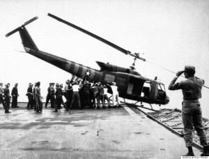 FILE - In this April 29, 1975 file photo, U.S. Navy personnel aboard the USS Blue Ridge push a helicopter into the sea off the coast of Vietnam in order to make room for more evacuation flights from Saigon. The war ended on April 30, 1975, with the fall of Saigon, now known as Ho Chi Minh City, to communist troops from the north. (AP Photo/File)