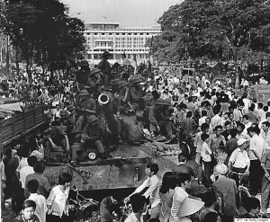 SAIGON, VIET NAM:  VIETNAM OUT    TO GO WITH "VIETNAM-US-WAR-ANNIVERSARY" (FILES) This 30 April 1975 file photo shows North Vietnamese soldiers sitting on top of a tank posted in front of the presidential palace of the US-backed regime as hundreds of Saigon residents gather around after the city falls to communist troops on the same day.  Vietnam will celebrate 30 April 2005 the 30th anniversary of the fall of Saigon, since renamed Ho Chi Minh City, a defining moment that sealed the catastrophic failure of US policy in Indo-China and cemented the communist victory in the long war.   VIETNAM OUT    AFP PHOTO  (Photo credit should read AFP/AFP/Getty Images)