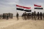 U.S. soldiers, left, participate in a training mission with Iraqi army soldiers outside Baghdad, Iraq, Wednesday, May 27, 2015. Islamic State extremists unleashed a wave of suicide attacks targeting the Iraqi army in western Anbar province, killing at least 17 troops in a major blow to government efforts to dislodge the militants from the sprawling Sunni heartland, an Iraqi military spokesman said Wednesday. (AP Photo/Khalid Mohammed)