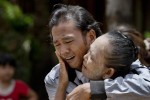 ADVANCE FOR RELEASE WEDNESDAY, JULY 1, 2015, AND THEREAFTER - In this May 16, 2015 photo, former slave fisherman Myint Naing and his mother, Khin Than, cry as they are reunited after 22 years at their village in Mon State, Myanmar. Myint, 40, is among hundreds of former slave fishermen who returned to Myanmar following an Associated Press investigation into the use of forced labor in Southeast Asias seafood industry. (AP Photo/Gemunu Amarasinghe)