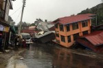 Apartments are destroyed following a landslide due to heavy rain in Harkhar, Chin State of Myanmar on July 30, 2015.  Floods triggered by torrential monsoon rains have killed at least 10 people in Myanmar in the last 48 hours, state media and officials reported on July 25, 2015. AFP PHOTO / Bik Lian