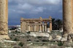 FILES - A picture taken on March 14, 2014 shows the Temple of Baal Shamin seen through two Corinthian columns in the ancient oasis city of Palmyra, 215 kilometres northeast of Damascus. Islamic State group jihadists on August 23, 2015 blew up the ancient temple of Baal Shamin in the UNESCO-listed Syrian city of Palmyra, the country's antiquities chief told AFP. "Daesh placed a large quantity of explosives in the temple of Baal Shamin today and then blew it up causing much damage to the temple," said Maamoun Abdulkarim, using another name for IS. IS, which controls swathes of Syria and neighbouring Iraq, captured Palmyra on May 21, sparking international concern about the fate of the heritage site described by UNESCO as of "outstanding universal value". AFP PHOTO/JOSEPH EID
