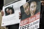 Placards of China's jailed Nobel laureate Liu Xiaobo and his wife Liu Xia are displayed by Chinese dissidents Wang Dan and Wuer Kaixi in front of the Presidential Office in Taipei February 27, 2013. REUTERS/Pichi Chuang