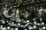 Iranian members of parliament attend a parliamentary session in Tehran on June 23, 2015. Iranian lawmakers passed a bill obliging the government to safeguard the country's "nuclear rights and achievements," despite talks with global powers on curbing the Islamic republic's disputed atomic programme. AFP PHOTO / BEHROUZ MEHRI