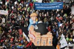 Consumer rights activists take part in a march to protest against the Transatlantic Trade and Investment Partnership (TTIP), mass husbandry and genetic engineering, in Berlin, Germany, October 10, 2015.   REUTERS/Fabrizio Bensch