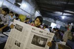 A worker arranges pages of the International Herald Tribune newspaper, which is printed for the first time in Myanmar, in Yangon September 23, 2013. The International Herald Tribune, which is the global edition of the New York Times, is the first international newspaper to be both printed and distributed in Myanmar, local media reported. REUTERS/Soe Zeya Tun (MYANMAR - Tags: MEDIA BUSINESS) - RTX13VTW