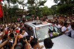 Myanmar pro-democracy leader Aung San Suu Ky smiles as she greets her supporters during her campaign in her constituency of Kawhmu township outside Yangon September 21, 2015. Suu Kyi was touring her constituency on the outskirts of Myanmar's commercial capital of Yangon on Monday, kicking off the third week of campaigning for the first free national vote in 25 years.  REUTERS/Soe Zeya Tun - RTS251B