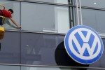 A worker cleans the facade of a Volkswagen dealership near the Andalusian capital of Seville, southern Spain, October 16, 2015.  REUTERS/Marcelo del Pozo