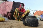 A displaced Somali woman sits outside her temporary dwelling after fleeing famine in the Marka Lower Shebbele regions to the capital Mogadishu September 20, 2014.  REUTERS/Feisal Omar