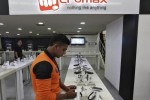 An employee stands at the counter of Micromax mobile phones at a showroom in New Delhi December 6, 2013. India's Micromax, which has become the country's No. 2 smartphone brand just five years after selling its first handset - a $30 made-in-China model - is looking to go upmarket and overseas. The unlisted company sold 6.8 million phones in the July-September quarter including 2.2 million smartphones, and is on track to surpass $1 billion in sales in the fiscal year ending in March. Picture taken December 6, 2013.  REUTERS/Adnan Abidi (INDIA - Tags: BUSINESS TELECOMS)