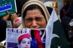 A mother weeps as she carries a picture of her slain son during a tribute to students who were killed in an attack on a school last year by Taliban gunmen, in Peshawar, Pakistan, Saturday, Feb. 7, 2015. Pakistani Taliban militants attacked an army-run school in the northwestern city of Peshawar on Dec. 16, 2014, killing 150 people, mostly children.  (AP Photo/Mohammad Sajjad)