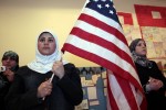 A young Muslim American female student holds the U.S. flag during a 'Children of the World' student pageant at the Islamic Center of America in Dearborn, Michigan, March 26, 2010.  A growing school of thought among counterterrorism specialists, and within the administration of U.S. President Barack Obama, argues that law enforcement should engage more deeply with the Muslim community. Their case has been bolstered by encouraging examples of outreach programs. Picture taken March 26. To match SPECIAL REPORT USA-SECURITY/HOMEGROWN  REUTERS/Rebecca Cook  (UNITED STATES - Tags: RELIGION POLITICS)