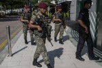 epa05119617 Malaysian Armed Forces with a Royal Malaysian Police patrol outside a shopping mall at Kuala Lumpur, Malaysia, 23 January 2016. Security at Malaysia's key entry points and mall such as airports, train stations, shopping and entertainment areaa in Kuala Lumpur has been tightened as a precaution against terror attacks, officials said.  EPA/FAZRY ISMAIL