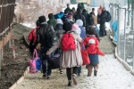 epa05088617 Refugees walk to a chartered train headed to Saalfeld, at the railway station of Passau, Germany, 05 January 2016. More than 1 million people, mainly from war-torn countries in the Middle East, sought asylum in Germany in 2015. EPA/ARMIN WEIGEL