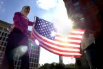 Alyzae Karim, left, and Zaizab Suleman, hold a U.S. flag during a rally against terrorism at the Kennedy Memorial in downtown Dallas, Saturday, Oct. 20, 2001. The Dallas-Fort Worth Muslim community hosted the rally. (AP Photo/LM Otero)