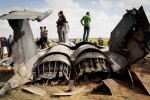 Libyans inspect the wreckage of a US  F15 fighter jet after it crashed in an open field in the village of  Bu Mariem, east of Benghazi, eastern Libya, Tuesday, March 22, 2011, with both crew ejecting safely. The U.S. Africa Command said both crew members were safe after what was believed to be a mechanical failure of the Air Force F-15. The aircraft, based out of Royal Air Force Lakenheath, England, was flying out of Italy's Aviano Air Base in support of Operation Odyssey Dawn.(AP Photo/Anja Niedringhaus)