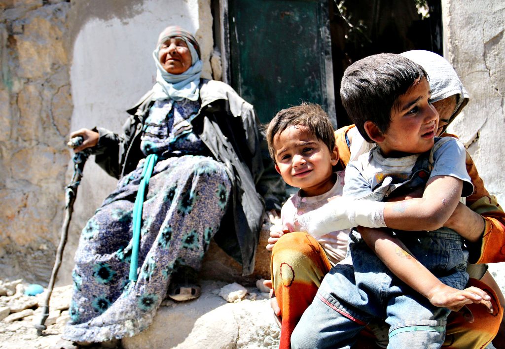 A Syrian woman comforts her children aft...A Syrian woman comforts her children after their house in the Sahour nieghbourhood of the northern Syrian city of Aleppo was bombed on May 14, 2014. Once home to some 2.5 million residents and considered Syria's economic powerhouse, Aleppo has been divided between government and opposition control since shortly after fighting there began in mid-2012. FP PHOTO / ZEIN AL-RIFAIZEIN AL-RIFAI/AFP/Getty Images