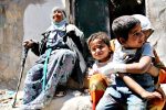 A Syrian woman comforts her children aft...A Syrian woman comforts her children after their house in the Sahour nieghbourhood of the northern Syrian city of Aleppo was bombed on May 14, 2014. Once home to some 2.5 million residents and considered Syria's economic powerhouse, Aleppo has been divided between government and opposition control since shortly after fighting there began in mid-2012. FP PHOTO / ZEIN AL-RIFAIZEIN AL-RIFAI/AFP/Getty Images