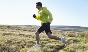 Man running in grassy field