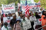 Members of Connecticut's Muslim community and their supporters hold signs at a rally on the grounds of the state Capitol in Hartford, Conn., Friday, Aug. 5, 2005. The rally was held by members of the state's Muslim community to strongly protest against terrorism. (AP Photo/Bob Child)