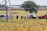 The partial frame of a hot air balloon is visible above a crop field as investigators comb the wreckage of a Saturday morning accident that left 16 people feared dead when the balloon crashed in Maxwell, Texas, U.S. July 30, 2016. Ralph Barrera/Austin American-Statesman/via REUTERS