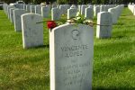 DENVER, CO - AUGUST 7: A red rose is left on top of the tombstone of American Muslim Vincente Lopez at Fort Logan National Cemetery on August 7, 2016 in Denver, Colorado. Mike Sexton, from Highlands Ranch, decided to put flowers on the gravestones of American Muslims who served our country in uniform and lost their lives to honor them.   This was sparked as a protest against the vilification of the family of fallen American hero Captain Humayun Khan by Republican presidential candidate Donald Trump.  Sexton asked that if you could not find the grave of a Muslim-American then place a flower on the grave of someone different than you in some way; someone of a different faith or ancestry. Because Fort Logan only allows flags to be placed on graves on Memorial day, those who attended mark the graves with flowers, rocks, and colorful glass stones. About 50 people turned out for the event. (Photo by Helen H. Richardson/The Denver Post)