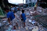 People stand amongst the rubble of fallen homes in Manta on April 17, 2016, after a powerful 7.8-magnitude earthquake struck Ecuador on April 16. 
At least 77 people were killed when a powerful 7.8-magnitude earthquake struck Ecuador, destroying buildings and a bridge and sending terrified residents scrambling from their homes, authorities in the Latin American country said on April 17. / AFP / JUAN CEVALLOS        (Photo credit should read JUAN CEVALLOS/AFP/Getty Images)