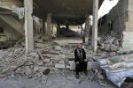 Palestinian Mukaram Keferna cries upon her return to what was the family house, destroyed by Israeli strikes in Beit Hanoun, northern Gaza Strip, Saturday, July 26, 2014. Thousands of Gaza residents who had fled Israel-Hamas fighting streamed back to devastated border areas during a lull Saturday, and were met by large-scale destruction: scores of homes were pulverized, wreckage blocked roads and power cables dangled in the streets. (AP Photo/Lefteris Pitarakis)