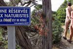 ILE DU LEVANT, FRANCE:  A couple of nudists stroll 21 June 2004 on a path leading to a beach on the Levant island, off the southern French port of Toulon. Back in the 1930s, early pioneering nudists settled on the remote and wildly beautiful Ile-du-Levant. Today mod-cons such as electricity have come to the Mediterranean isle but to save the environment, there are still no street-lights at night. AFP PHOTO BORIS HORVAT  (Photo credit should read BORIS HORVAT/AFP/Getty Images)