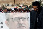 Relatives and activists hold a picture of Jordanian writer Nahed Hattar, who was shot dead, with Jordanian national flags during his funeral in the town of Al-Fuheis near Amman, Jordan, September 28, 2016. REUTERS/Muhammad Hamed     TPX IMAGES OF THE DAY      - RTSPV8H