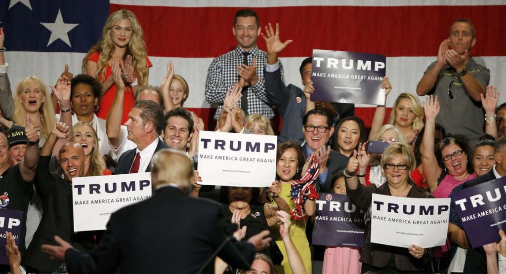 Republican presidential candidate Donald Trump turns around to supporters behind him as he speaks before a crowd of over 3,500 Saturday, July 11, 2015, in Phoenix. (AP Photo/Ross D. Franklin)