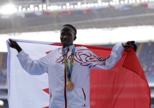 Bahrain's gold medal winner Ruth Jebet holds the Bahrain flag during the ceremony for the women's 3000-meter steeplechase final during the athletics competitions of the 2016 Summer Olympics at the Olympic stadium in Rio de Janeiro, Brazil, Monday, Aug. 15, 2016. (AP Photo/Natacha Pisarenko)