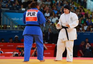 Saudi Arabia's Wojdan Shaherkani (white) competes with Puerto Rico's Melissa Mojica (blue) during their women's +78kg judo contest match of the London 2012 Olympic Games on August 3, 2012 at the ExCel arena in London. AFP PHOTO / MIGUEL MEDINA / AFP PHOTO / MIGUEL MEDINA