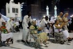 Elderly and walk-impaired Muslim pilgrims circle in their wheelchairs around the Kaaba as they perform Tawaf at the Grand Mosque in the Saudi holy city of Mecca early morning on November 9, 2010. The Kaaba, Islam's holiest site which stands in the centre of Mecca's Grand Mosque, contains the holy Black Stone which is believed to be the only piece remaining from an altar built by Abraham.  AFP PHOTO/MUSTAFA OZER / AFP PHOTO / MUSTAFA OZER