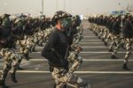 FILE - In this Thursday, Sept. 17, 2015 file photo, Saudi security forces, whose faces display the word "Decisive" take part in a military parade in preparation for the annual Hajj pilgrimage in Mecca, Saudi Arabia. Saudi Arabia said Tuesday, Dec. 15, 2015 that 34 nations have agreed to form a new "Islamic military alliance" to fight terrorism with a joint operations center based in the kingdom's capital, Riyadh. (AP Photo/Mosa'ab Elshamy, File)