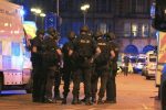 Armed police gather at Manchester Arena after reports of an explosion at the venue during an Ariana Grande gig  in Manchester, England Monday, May 22, 2017. Several people have died following reports of an explosion Monday night at an Ariana Grande concert in northern England, police said. A representative said the singer was not injured. (Peter Byrne/PA via AP)