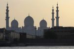 A surfer paddles in front of the Sheikh Zayed Grand Mosque in Abu Dhabi, United Arab Emirates, Tuesday, April 25, 2017. (AP Photo/Kamran Jebreili)