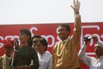 FILE PHOTO - Myanmar pro-democracy leader Aung San Suu Kyi gives a speech as Phyo Min Thein (2nd R) acknowledges the crowd  at a stadium in Hlegu township February 15, 2012.  REUTERS/Soe Zeya Tun