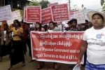 In this image made from video, protesters march in Sittwe, Myanmar, on Sunday, Oct. 22, 2017. Hundreds of hard-line Buddhists protested Sunday to urge Myanmar's government not to repatriate the nearly 600,000 minority Rohingya Muslims who have fled to Bangladesh since late August to escape violence in Myanmar's Rakhine State. (AP Photo)