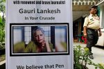 REFILE - ADDING RESTRICTIONS A security guard walks past a placard installed at the Press Club of Kolkata in solidarity with Gauri Lankesh, a senior Indian journalist who according to police was shot dead outside her home on Tuesday by unidentified assailants in southern city of Bengaluru, in Kolkata, India September 6, 2017. REUTERS/Rupak De Chowdhuri          NO RESALES. NO ARCHIVES.