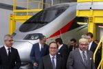 France's President Francois Hollande (C) and Morocco's King Mohammed VI (R) visit the train maintenance center of the Tangier-Casablanca high-speed rail line in Tangiers, Morocco September 19, 2015. Hollande arrived in Morocco for a two-day visit. REUTERS/Youssef Boudlal