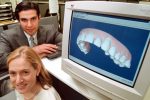 Kelsey Wirth, president of Align Technology, bottom, and Chief Executive Officer, Zia Chishti, show off their company's state of the art technology used to straighten teeth without the metal of traditional braces, at their offices in Mt. View, Calif., Friday, Sept. 15, 2000. The company is unveiling a $38 million marketing campaign, the largest in orthodonics history, Sept. 19, 2000. (AP Photo/John Todd)