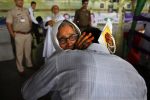 An Indian Muslim woman pilgrim cries as she hugs her son at the airport before leaving for the annual hajj pilgrimage to the holy city of Mecca in New Delhi, India, Wednesday, Sept. 3, 2014. More than 3 million Muslims worldwide make the pilgrimage each year, but recent reports say Saudi Arabia plans to restrict the number this year to about 1.3 million because of construction projects in the holy city. (AP Photo /Manish Swarup)