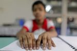 Meem, 13, takes part in a lesson at the Baptist Mission Integrated School (BMIS) in Dhaka May 19, 2010. About 76 visually impaired girls and women reside in BMIS where they receive special education which covers mobility, Braille, daily living skills, hygiene and physical exercises. REUTERS/Andrew Biraj (BANGLADESH - Tags: SOCIETY EDUCATION) - GM1E65J192D01