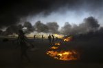 Palestinian protesters burn tires during a protest at the Gaza Strip's border with Israel, east of Khan Younis, Tuesday, May 15, 2018. Israel faced a growing backlash Tuesday and new charges of using excessive force, a day after Israeli troops firing from across a border fence killed dozens of Palestinians and wounded more than 2,700 at a mass protest in Gaza. (AP Photo/Adel Hana)